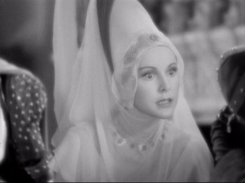 Movie still from “If I Were King” (1938), directed by Frank Lloyd – A black and white photo of a woman wearing a veil; Close Up shot, Over the shoulder angle