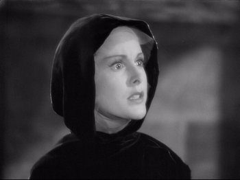 Movie still from “If I Were King” (1938), directed by Frank Lloyd – A young woman wearing a black hooded sweatshirt; Close Up shot, High angle