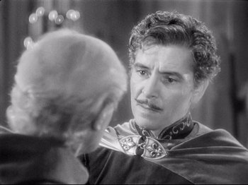 Movie still from “If I Were King” (1938), directed by Frank Lloyd – A man with a mustache is looking at another man; Close Up shot, Over the shoulder angle