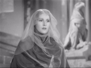 Movie still from “If I Were King” (1938), directed by Frank Lloyd – A black and white photo of a woman wearing a veil; Close Up shot, Low angle