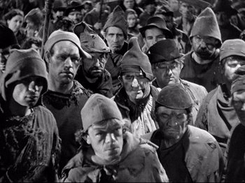 Movie still from “If I Were King” (1938), directed by Frank Lloyd – A group of men in hats and uniforms; Medium shot, High angle