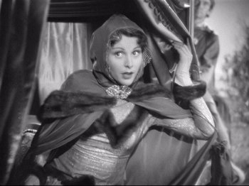 Movie still from “If I Were King” (1938), directed by Frank Lloyd – A black and white photo of a woman wearing a cape; Medium shot, High angle