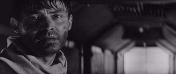 Movie still from “Voyage to the End of the Universe” (1963), directed by Jindrich Polák – Black and white photograph of a man with a bruised face; Close Up shot, Low angle