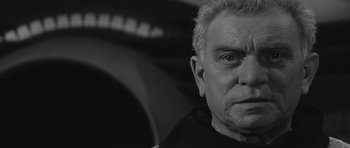 Movie still from “Voyage to the End of the Universe” (1963), directed by Jindrich Polák – An older man is looking into the camera; Close Up shot, Low angle