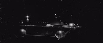 Movie still from “Voyage to the End of the Universe” (1963), directed by Jindrich Polák – A black and white photo of a night sky; Extreme Wide shot, High angle