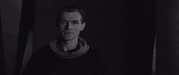 Movie still from “Voyage to the End of the Universe” (1963), directed by Jindrich Polák – Black and white photograph of a man wearing a scarf; Close Up shot, Low angle