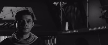 Movie still from “Voyage to the End of the Universe” (1963), directed by Jindrich Polák – A black and white photo of a man standing in front of a mirror; Close Up shot, Low angle