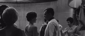 Movie still from “Voyage to the End of the Universe” (1963), directed by Jindrich Polák – A man and a woman standing next to each other; Medium shot, Low angle