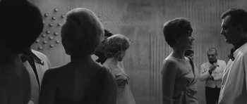 Movie still from “Voyage to the End of the Universe” (1963), directed by Jindrich Polák – A group of women standing next to each other in front of a wall; Medium shot, Low angle