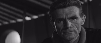 Movie still from “Voyage to the End of the Universe” (1963), directed by Jindrich Polák – Black and white photograph of a man with a serious look; Close Up shot, Low angle