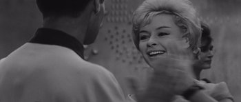 Movie still from “Voyage to the End of the Universe” (1963), directed by Jindrich Polák – An old photo of a woman and a man smiling at each other; Close Up shot, Low angle