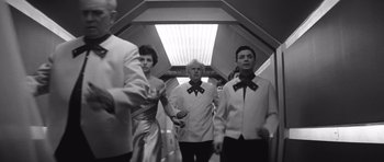 Movie still from “Voyage to the End of the Universe” (1963), directed by Jindrich Polák – A black and white photo of a group of people; Medium shot, Low angle