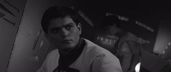 Movie still from “Voyage to the End of the Universe” (1963), directed by Jindrich Polák – A black and white photo of a man in a tie; Close Up shot, Over the shoulder angle