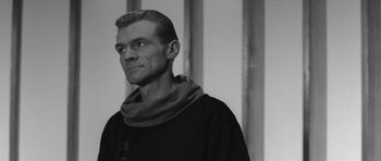 Movie still from “Voyage to the End of the Universe” (1963), directed by Jindrich Polák – Black and white photograph of a man wearing a monk's outfit; Close Up shot, Low angle
