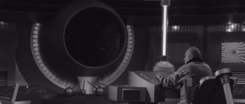 Movie still from “Voyage to the End of the Universe” (1963), directed by Jindrich Polák – A man is standing in front of a large telescope; Medium shot, Low angle