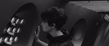 Movie still from “Voyage to the End of the Universe” (1963), directed by Jindrich Polák – A black and white photo of a woman with short hair; Close Up shot, High angle