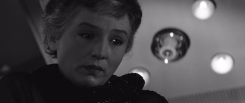 Movie still from “Voyage to the End of the Universe” (1963), directed by Jindrich Polák – A black and white photo of a woman looking at the camera; Close Up shot, Over the shoulder angle