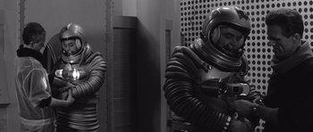 Movie still from “Voyage to the End of the Universe” (1963), directed by Jindrich Polák – A black and white photo of a person in a diving suit; Medium shot, Low angle