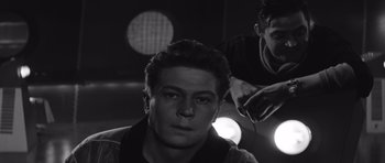 Movie still from “Voyage to the End of the Universe” (1963), directed by Jindrich Polák – A black - and - white photo of a man and another man; Close Up shot, Low angle