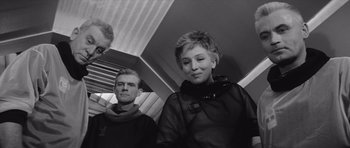 Movie still from “Voyage to the End of the Universe” (1963), directed by Jindrich Polák – A man and a woman on a train; Medium shot, Low angle