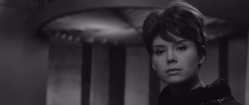 Movie still from “Voyage to the End of the Universe” (1963), directed by Jindrich Polák – A black and white photo of a woman with short hair; Close Up shot, Low angle