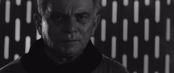 Movie still from “Voyage to the End of the Universe” (1963), directed by Jindrich Polák – An older man in a black and white photo; Close Up shot, Low angle