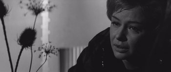Movie still from “Voyage to the End of the Universe” (1963), directed by Jindrich Polák – A black and white photo of a woman crying; Close Up shot, Over the shoulder angle