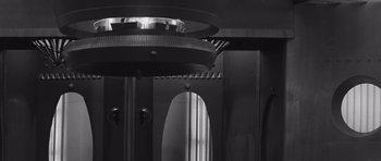 Movie still from “Voyage to the End of the Universe” (1963), directed by Jindrich Polák – A black and white photo of an elevator; Wide shot, Low angle