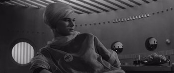 Movie still from “Voyage to the End of the Universe” (1963), directed by Jindrich Polák – Black and white photograph of a woman wearing a nurse's uniform; Close Up shot, Low angle