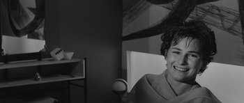 Movie still from “Voyage to the End of the Universe” (1963), directed by Jindrich Polák – A black - and - white photo of a woman smiling; Close Up shot, High angle