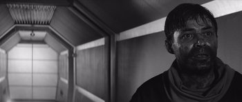 Movie still from “Voyage to the End of the Universe” (1963), directed by Jindrich Polák – Black and white photograph of a man in front of a wall; Close Up shot, Low angle