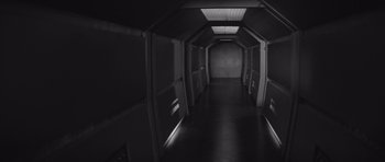Movie still from “Voyage to the End of the Universe” (1963), directed by Jindrich Polák – An empty hallway with a light shining on the wall; Wide shot, High angle