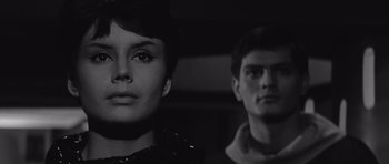 Movie still from “Voyage to the End of the Universe” (1963), directed by Jindrich Polák – A man and a woman standing next to each other; Close Up shot, Low angle