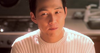Movie still from “Il Mare” (2000), directed by Hyun-seung Lee – A person wearing a white sweater; Close Up shot, High angle