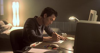 Movie still from “Il Mare” (2000), directed by Hyun-seung Lee – A man writing on a piece of paper at a desk; Medium shot, High angle