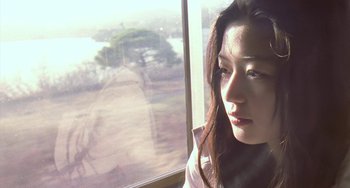 Movie still from “Il Mare” (2000), directed by Hyun-seung Lee – A woman looking out of a window at the beach; Close Up shot, Low angle