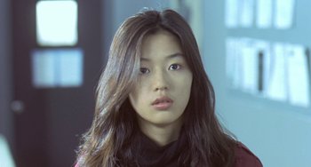 Movie still from “Il Mare” (2000), directed by Hyun-seung Lee – A woman with long brown hair wearing a black scarf; Close Up shot, Low angle