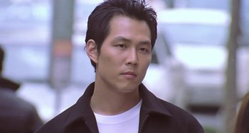 Movie still from “Il Mare” (2000), directed by Hyun-seung Lee – A person wearing a black jacket; Close Up shot, Low angle