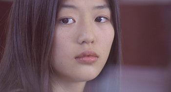 Movie still from “Il Mare” (2000), directed by Hyun-seung Lee – A young woman's face; Close Up shot, Over the shoulder angle