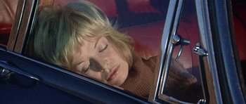 Movie still from “Images” (1972), directed by Robert Altman – A woman sleeping in the back seat of a car; Close Up shot, High angle