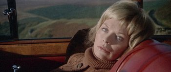 Movie still from “Images” (1972), directed by Robert Altman – A person sitting in a car; Close Up shot, High angle