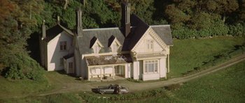 Movie still from “Images” (1972), directed by Robert Altman – An aerial view of a house with a truck parked in front of it; Extreme Wide shot, High angle