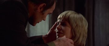 Movie still from “Images” (1972), directed by Robert Altman – A man and a woman touching each other's face; Close Up shot, Over the shoulder angle