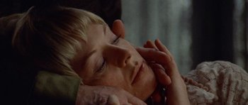 Movie still from “Images” (1972), directed by Robert Altman – A person with their hand on a mans face; Close Up shot, High angle
