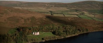 Movie still from “Images” (1972), directed by Robert Altman – An aerial view of a house on a hillside; Extreme Wide shot, High angle