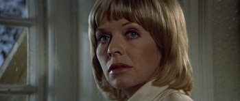 Movie still from “Images” (1972), directed by Robert Altman – A person wearing a white shirt with blue eyes; Close Up shot, Low angle