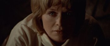 Movie still from “Images” (1972), directed by Robert Altman – A woman's face in the dark; Close Up shot, Low angle