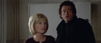 Movie still from “Images” (1972), directed by Robert Altman – A man and a woman standing next to each other in a room; Close Up shot, Low angle