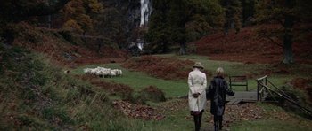 Movie still from “Images” (1972), directed by Robert Altman – Two women are walking near a waterfall with sheep in the background; Extreme Wide shot, High angle