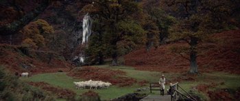 Movie still from “Images” (1972), directed by Robert Altman – A herd of sheep grazing on a lush green hillside; Extreme Wide shot, High angle